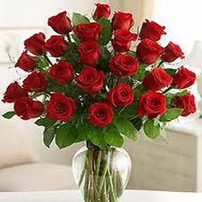 24 red roses in a glass vase