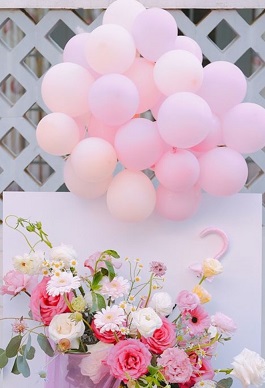20 Pink Balloons on sticks tied with a basket with pink and white roses